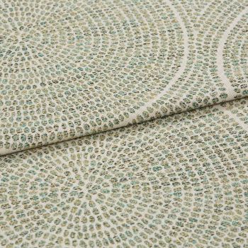 Woven upholstery fabric with small grid and concentric circular motif, folded to show layered edge and textured weave, close-up on a flat surface under soft, neutral lighting.