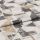 Folded textile sample with distressed geometric print—overlapping triangles and rectangles in beige, tan and charcoal on off-white—laid flat with a visible central fold under soft studio lighting.