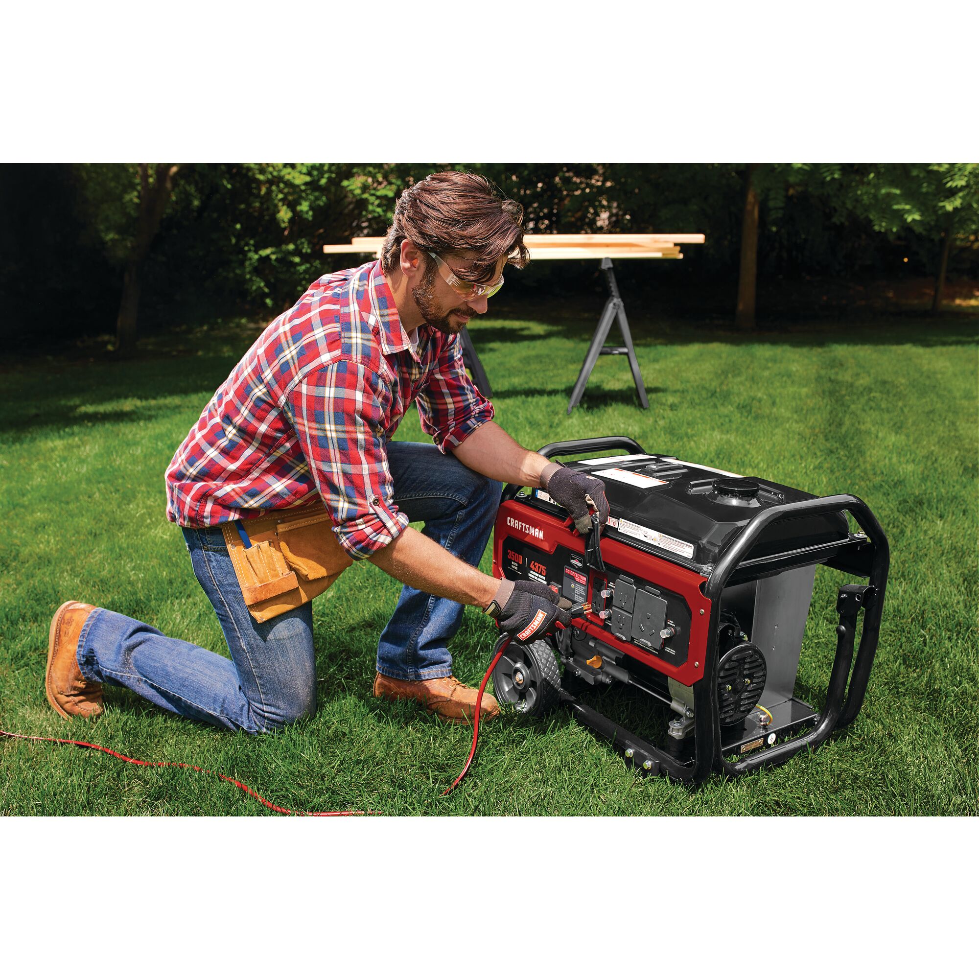3500 watt portable generator being used by a person.