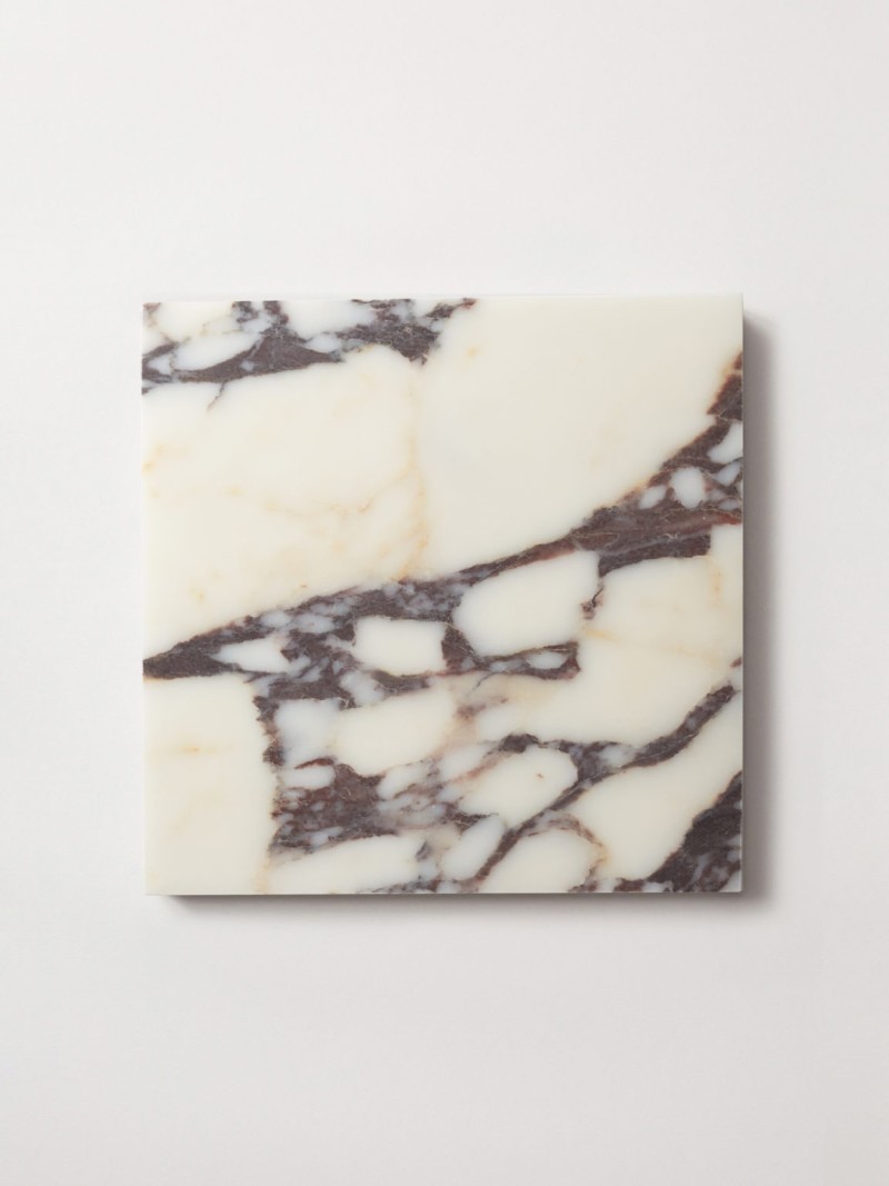 a marble cutting board on a white surface.