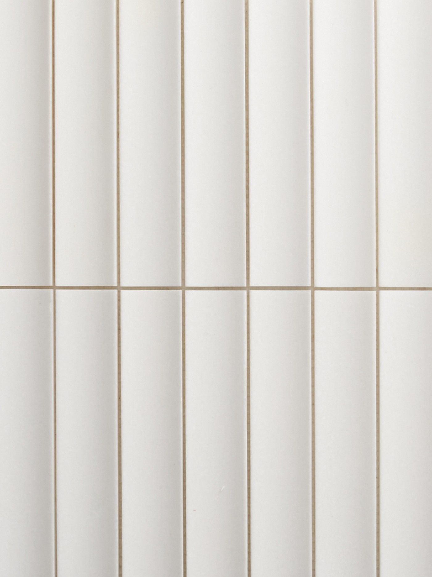 a close up of a white tiled wall.