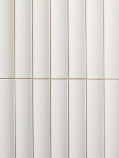 a close up of a white tiled wall.