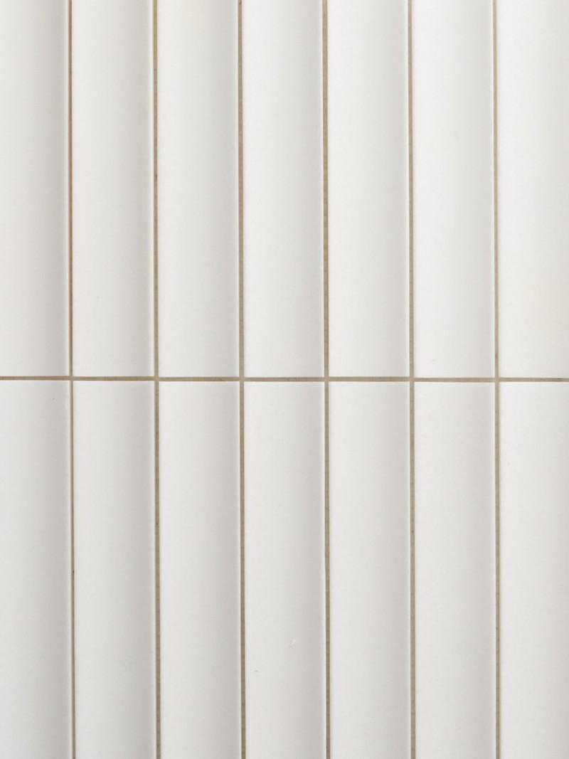 a close up of a white tiled wall.