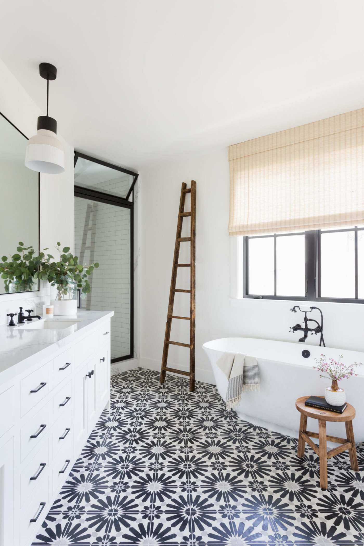 a bathroom with a black and white tile floor.