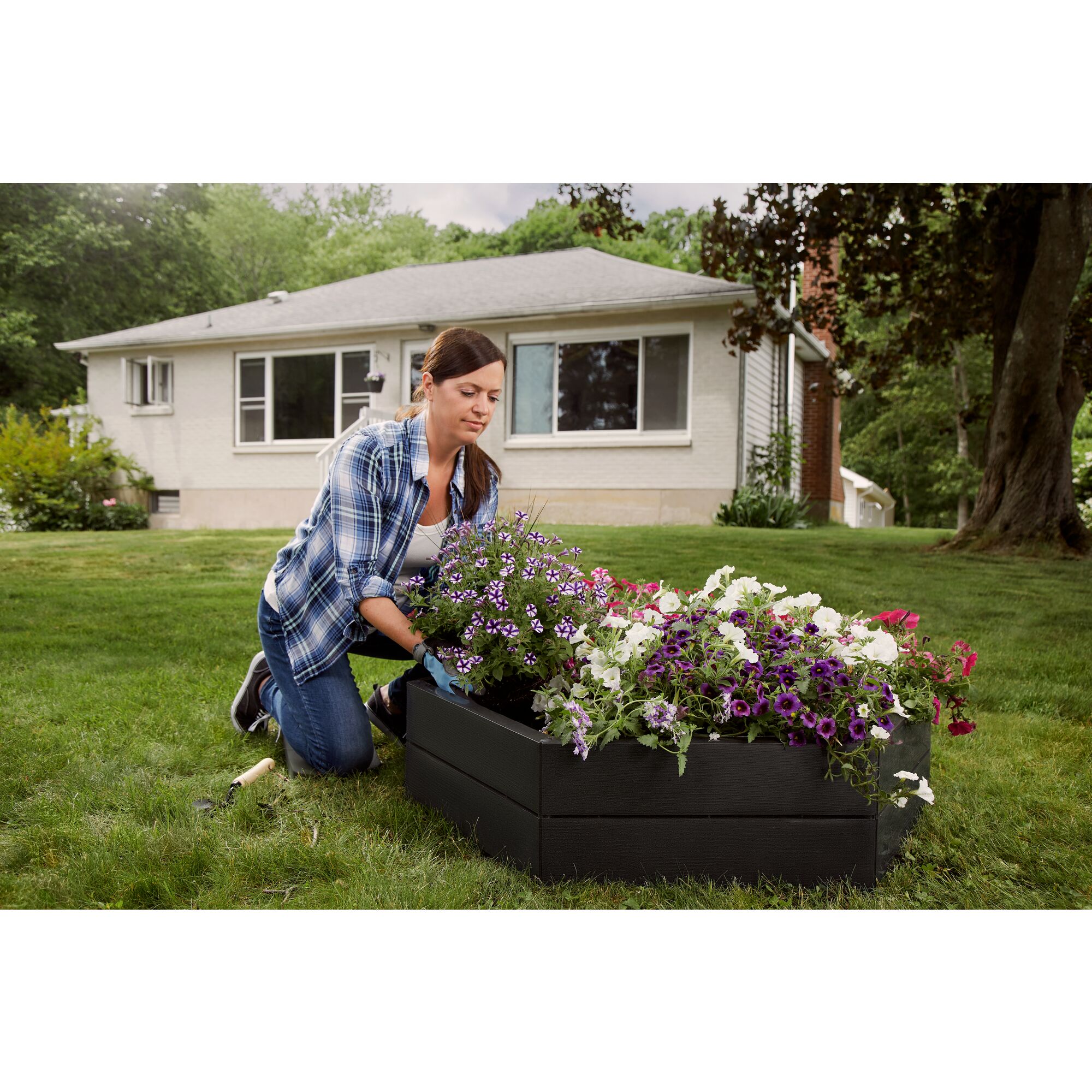 Black and Decker raised garden bed being set up by a person in a yard