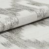 Folded woven fabric with silver metallic horizontal stripes, tightly textured and slightly rolled; resting on a matching fabric surface in soft, neutral studio lighting, close-up detail.