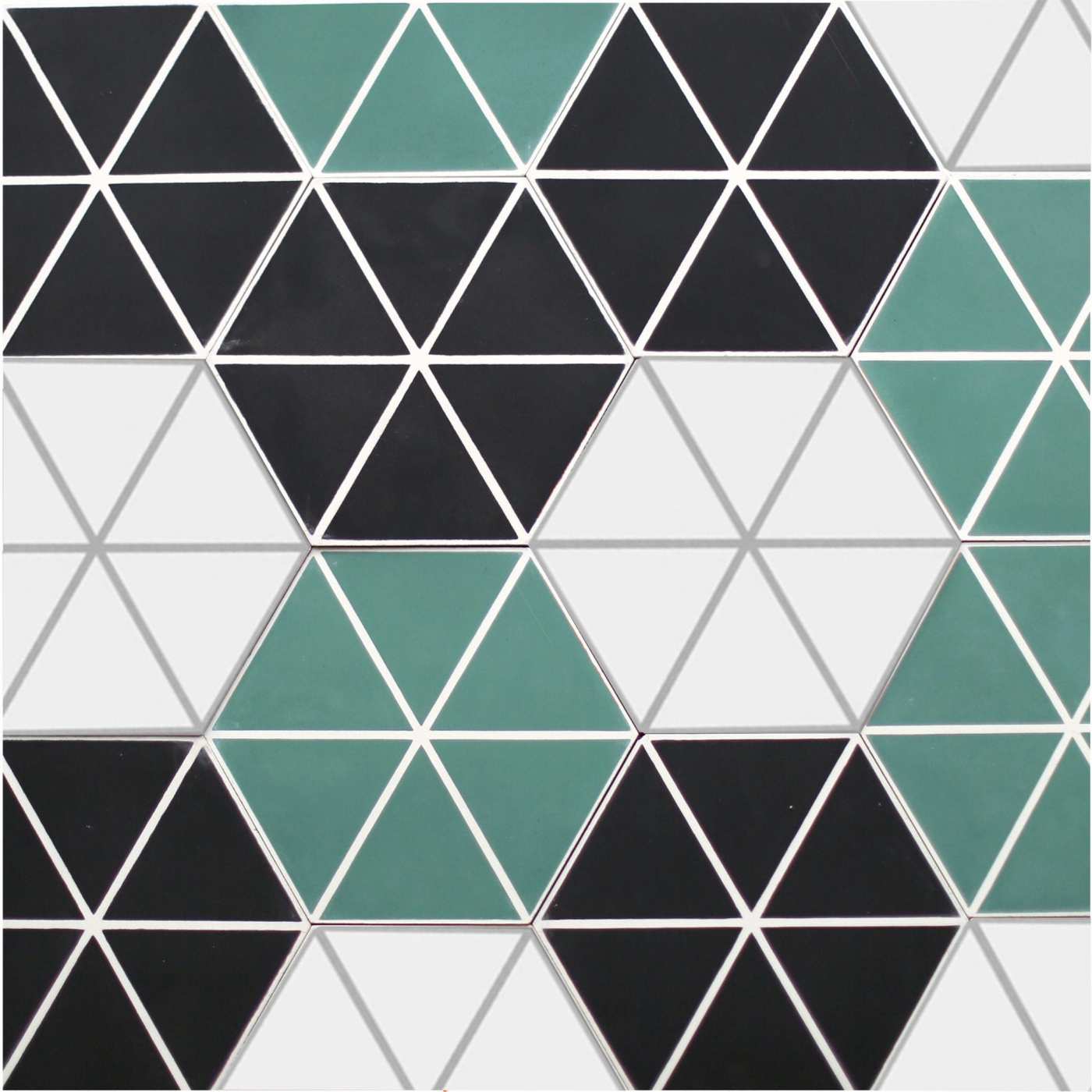 a surface with white, black, and green hexagon tiles.