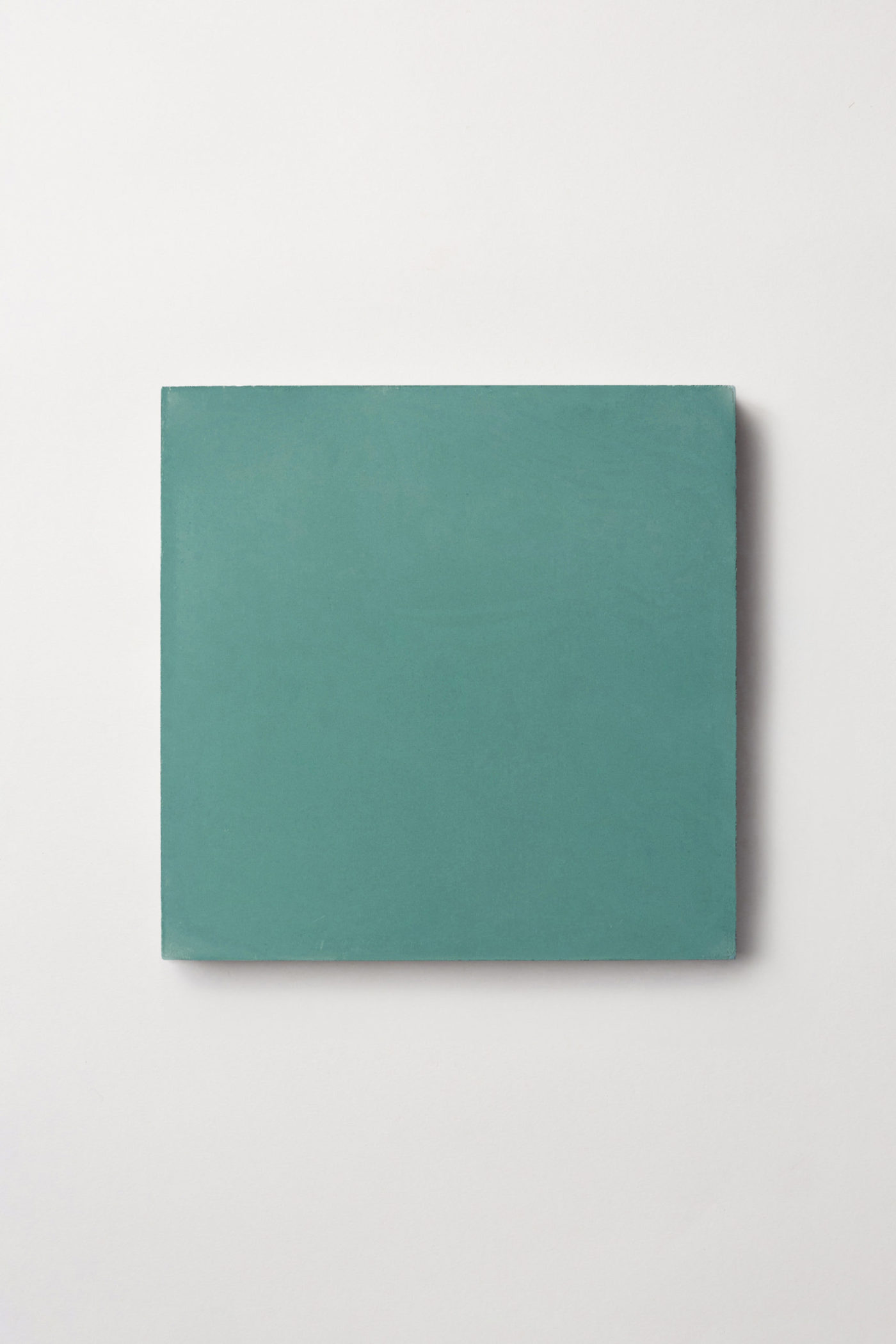 a teal colored square tiles on a white background.