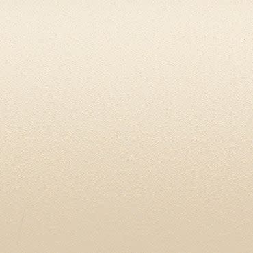 Beige stippled wall surface showing a fine, pebbled texture; evenly lit and uniformly colored; closely framed, neutral interior background with no visible fixtures, shadows, or distinguishing features.