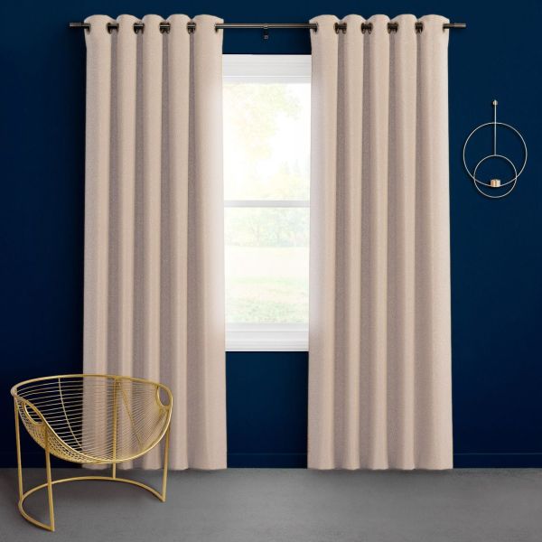 Textured beige grommet-top curtains on a metal rod, slightly parted to reveal a bright window filtering daylight; against a deep navy wall with a gold wire chair.