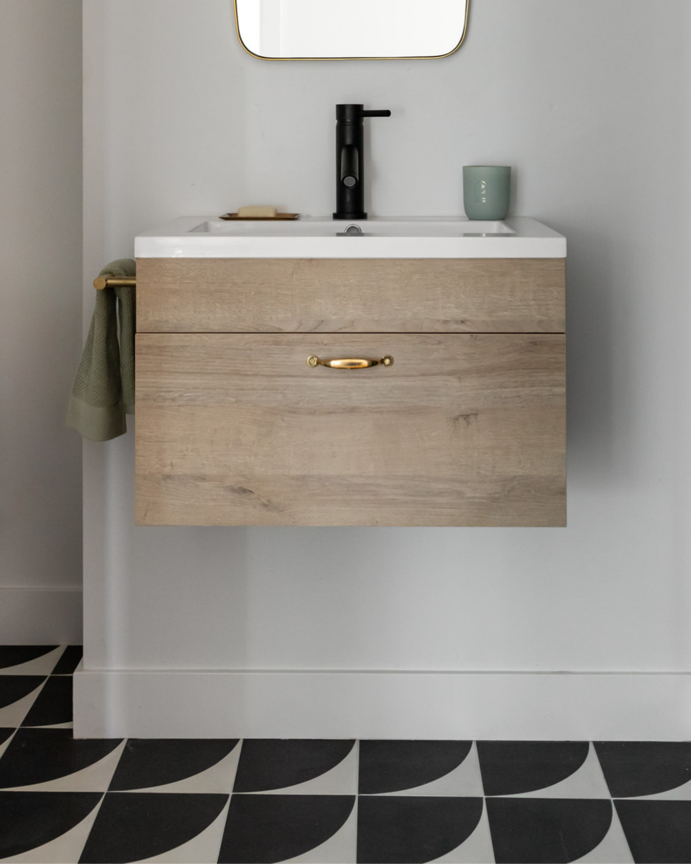 a bathroom with a black and white tiled floor.