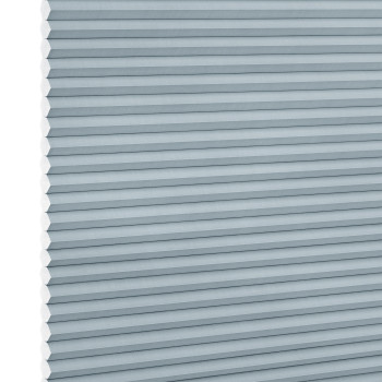 Light-blue cellular (honeycomb) blind, fully lowered with horizontal pleats and hexagonal cells visible at the left edge; blocking light in a close-up view against a white background.