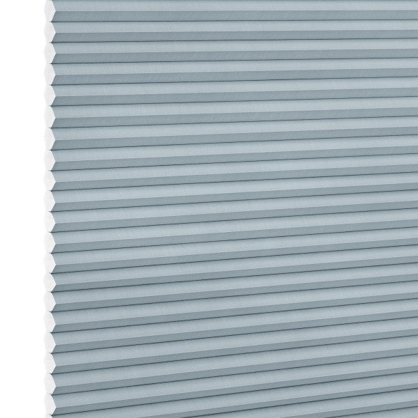 Light-blue cellular (honeycomb) blind, fully lowered with horizontal pleats and hexagonal cells visible at the left edge; blocking light in a close-up view against a white background.
