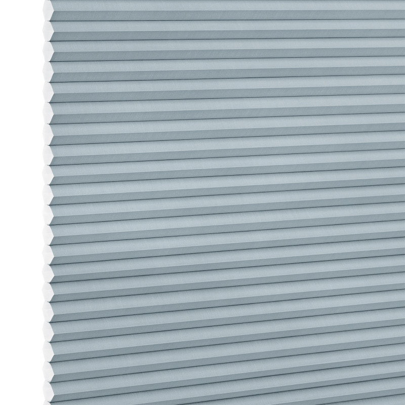 Light-blue cellular (honeycomb) blind, fully lowered with horizontal pleats and hexagonal cells visible at the left edge; blocking light in a close-up view against a white background.