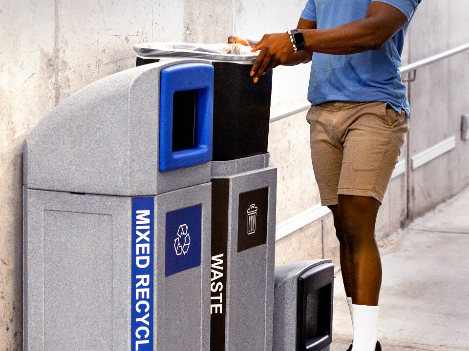 double waste and mixed recycling containers being serviced showing the liner being pulled out in a transit terminal
