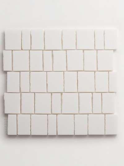 a white tile is laid out on a white surface.