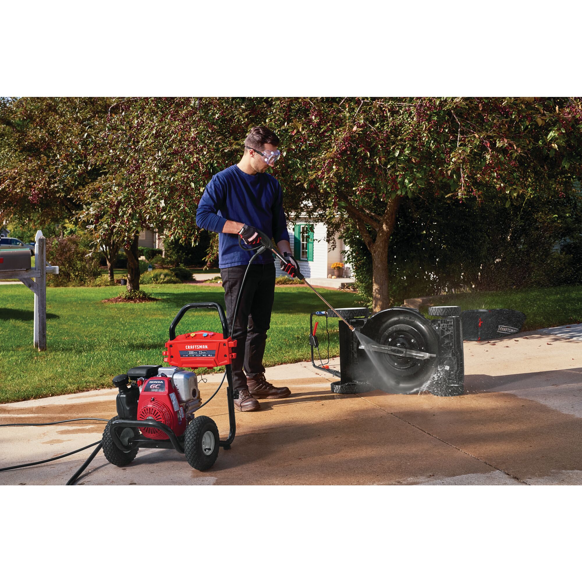 3300 Max P S I / 2.3 max G P M Pressure washer being used by a person to wash item.