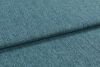 Teal textured upholstery fabric, folded into overlapping layers with visible weave and nap; lying flat as a close-up sample under soft diffuse lighting, showing subtle color variation.