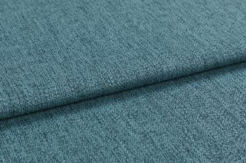 Teal textured upholstery fabric, folded into overlapping layers with visible weave and nap; lying flat as a close-up sample under soft diffuse lighting, showing subtle color variation.