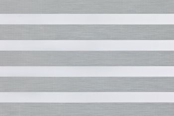 A dual-layer zebra roller blind with alternating opaque white and sheer gray textured horizontal bands across the window; filtering and diffusing daylight while partially blocking view; neutral indoor lighting.