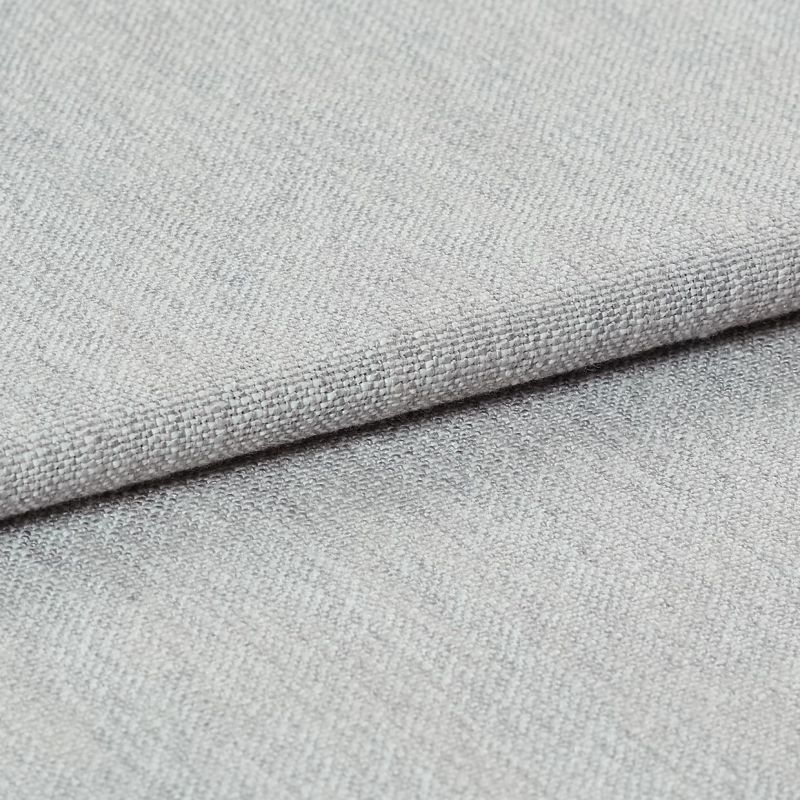 Light gray woven fabric, folded with a visible hem edge across the frame; tightly textured weave and subtle nap; close-up studio-lit shot on a neutral surface, soft even lighting.
