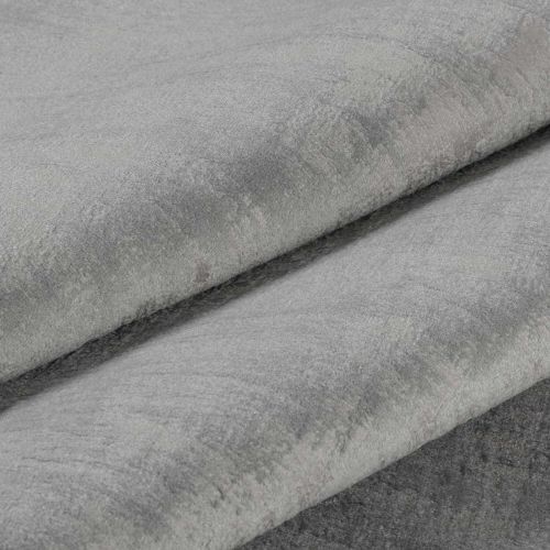 Folded grey plush velvet fabric, three overlapping layers with visible nap and subtle sheen; layered diagonally in a close-up product-style shot with soft, even lighting.