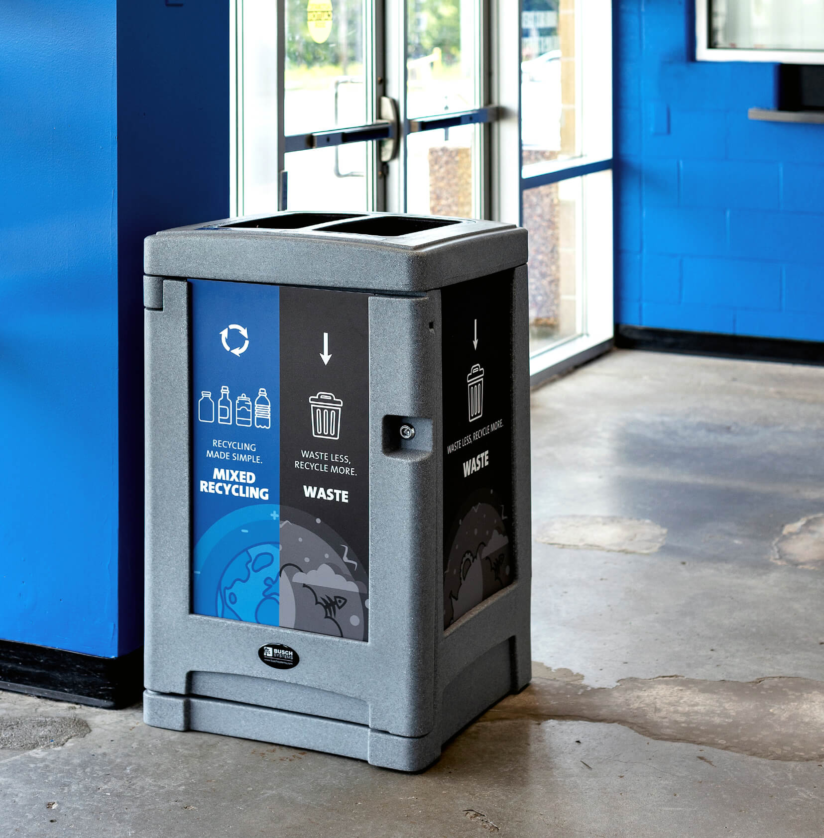 double stream waste and mixed recyclables container with big body signs and locking door inside a skating rink