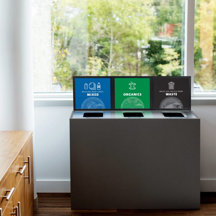 high-end mixed recyclables and waste container in a medical office building in front of a window with trees