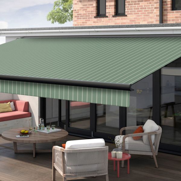 Green, diagonally striped retractable awning extended from house facade, shading the sliding glass doors. It filters daylight over a patio with cushioned seating, round coffee table, and brick upper wall.