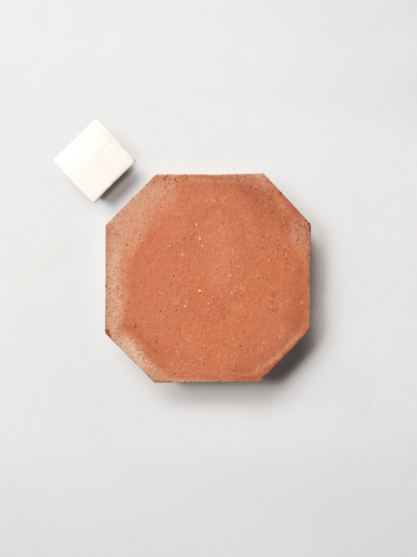 white and terracotta tiles on a white surface.