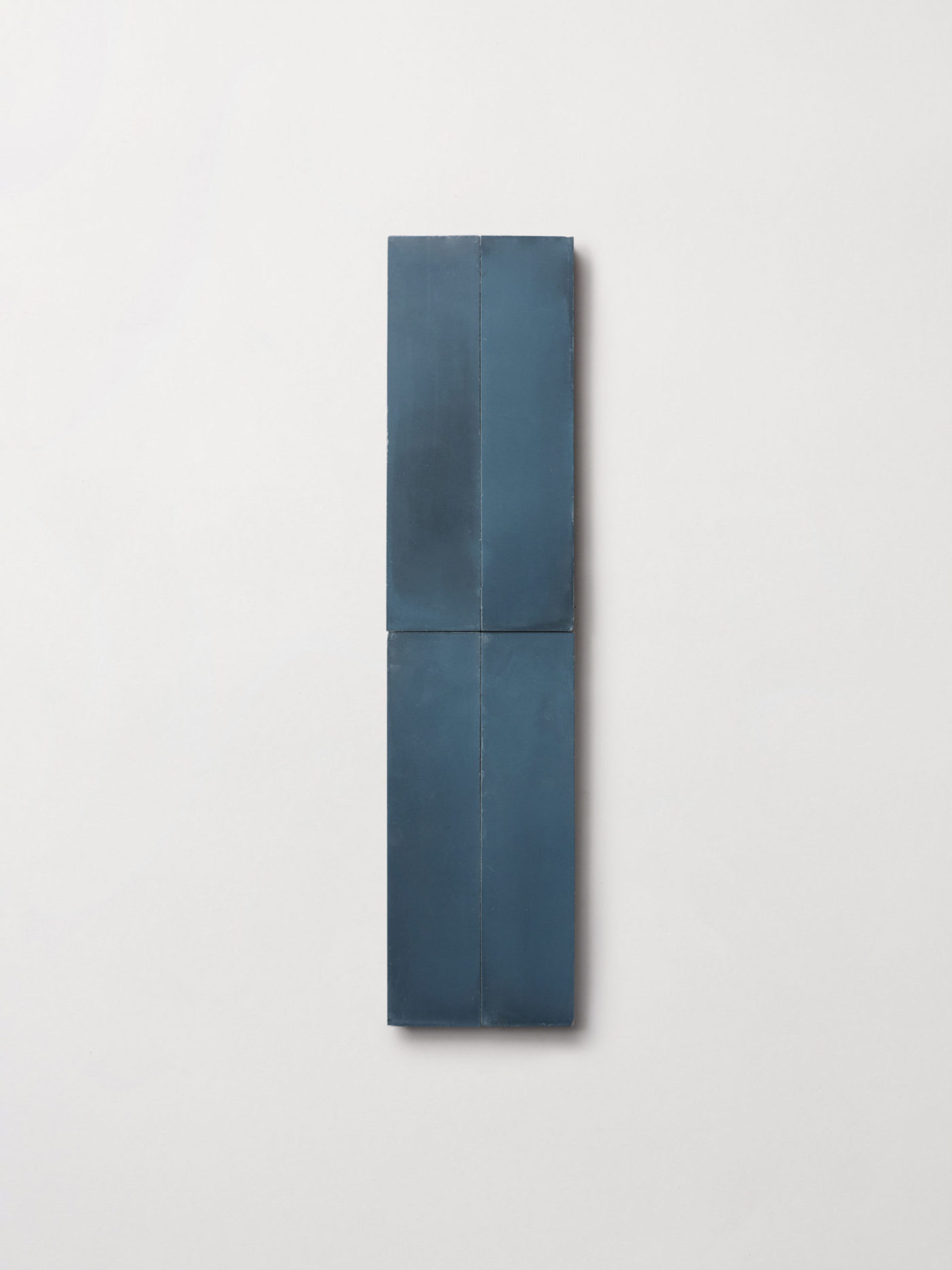 four blue rectangle tiles on a white surface.