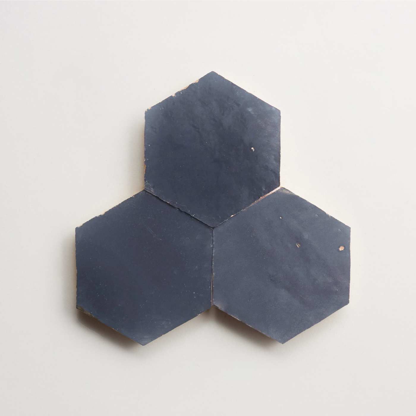 a set of three blue hexagonal tiles on a white surface.