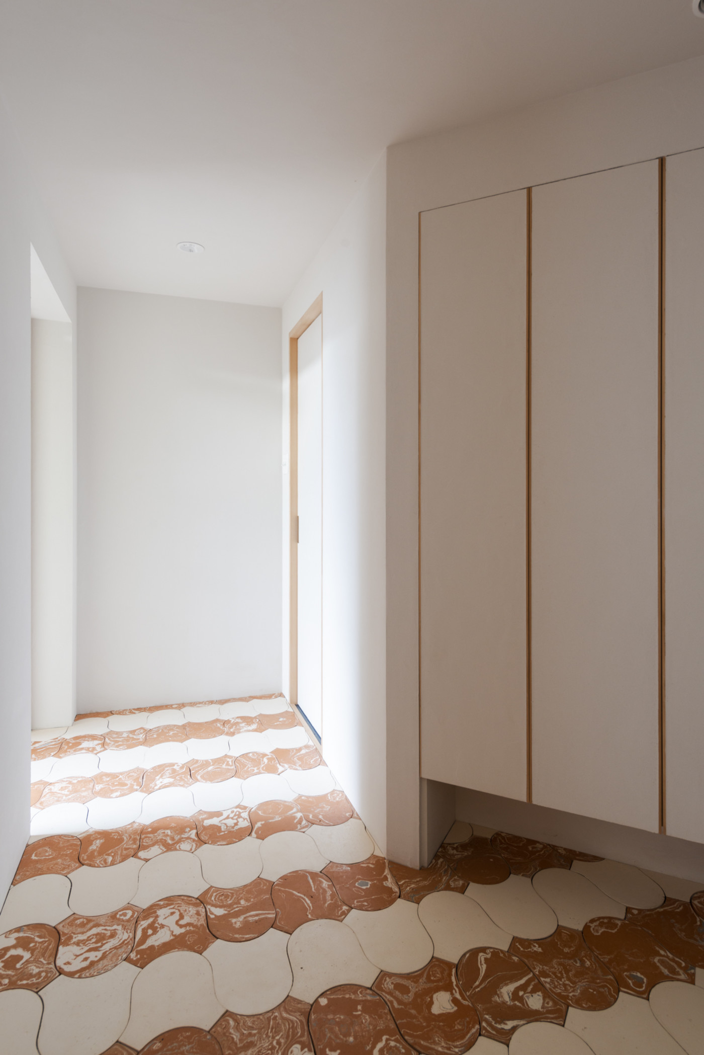 a room with a red and white tiled floor.