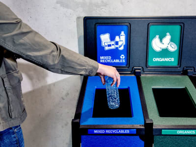 recycling plastic lumber waste and recycling container with color-coded signs and labels in a university campus