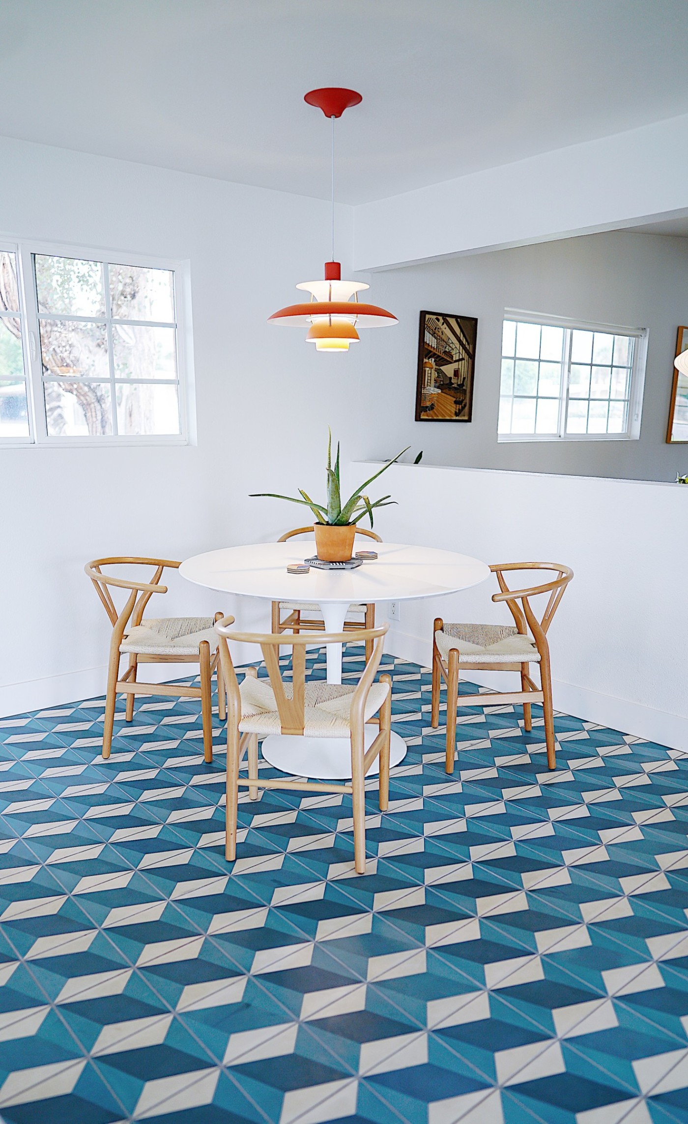 a blue and white tiled floor in a dining room.