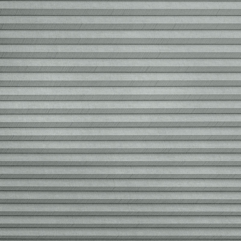 Gray horizontal pleated fabric blinds with subtle herringbone texture; fully closed, filtering soft light; fills the frame, neutral indoor lighting, no surrounding room details visible.