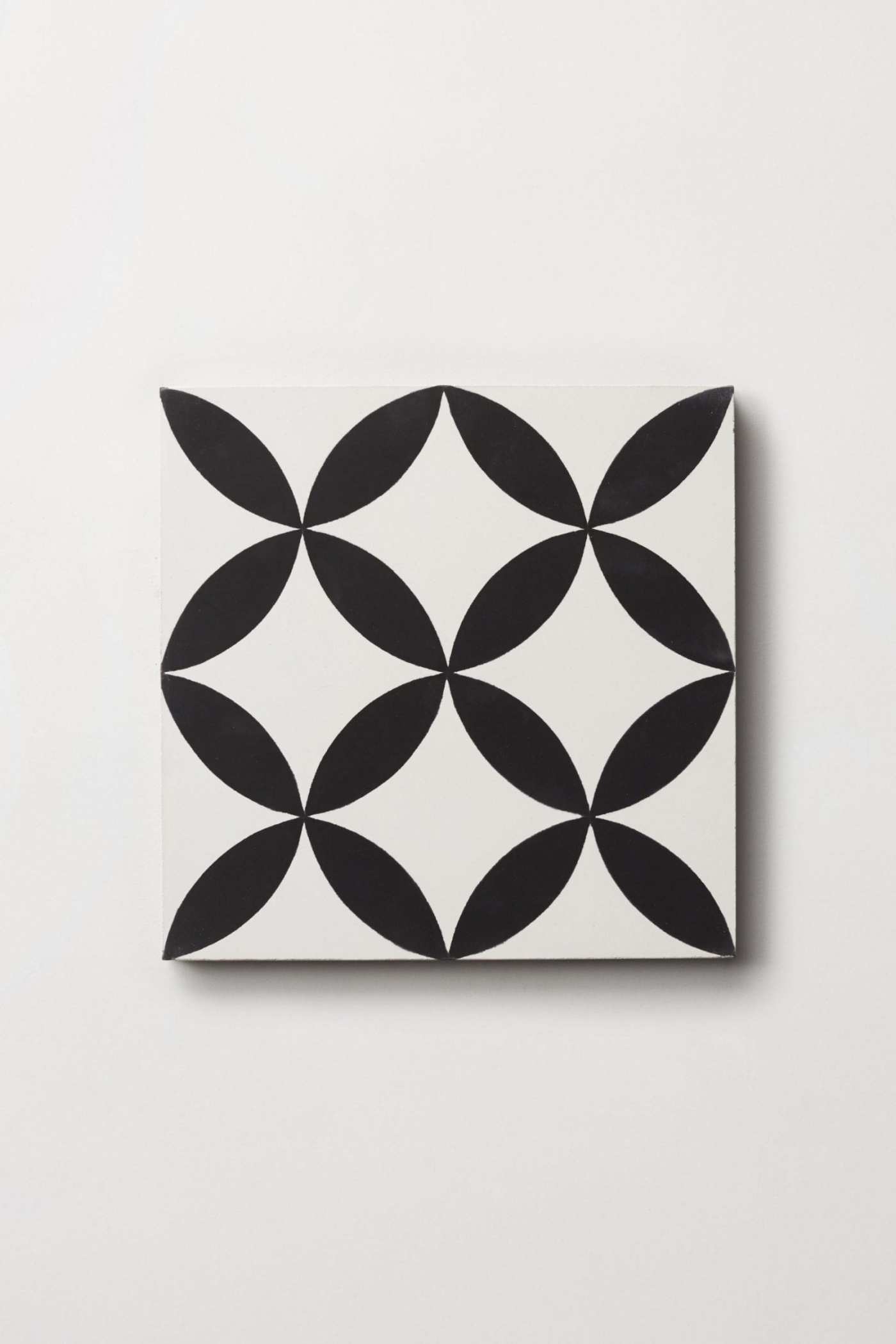 a black and white tile on a white surface.