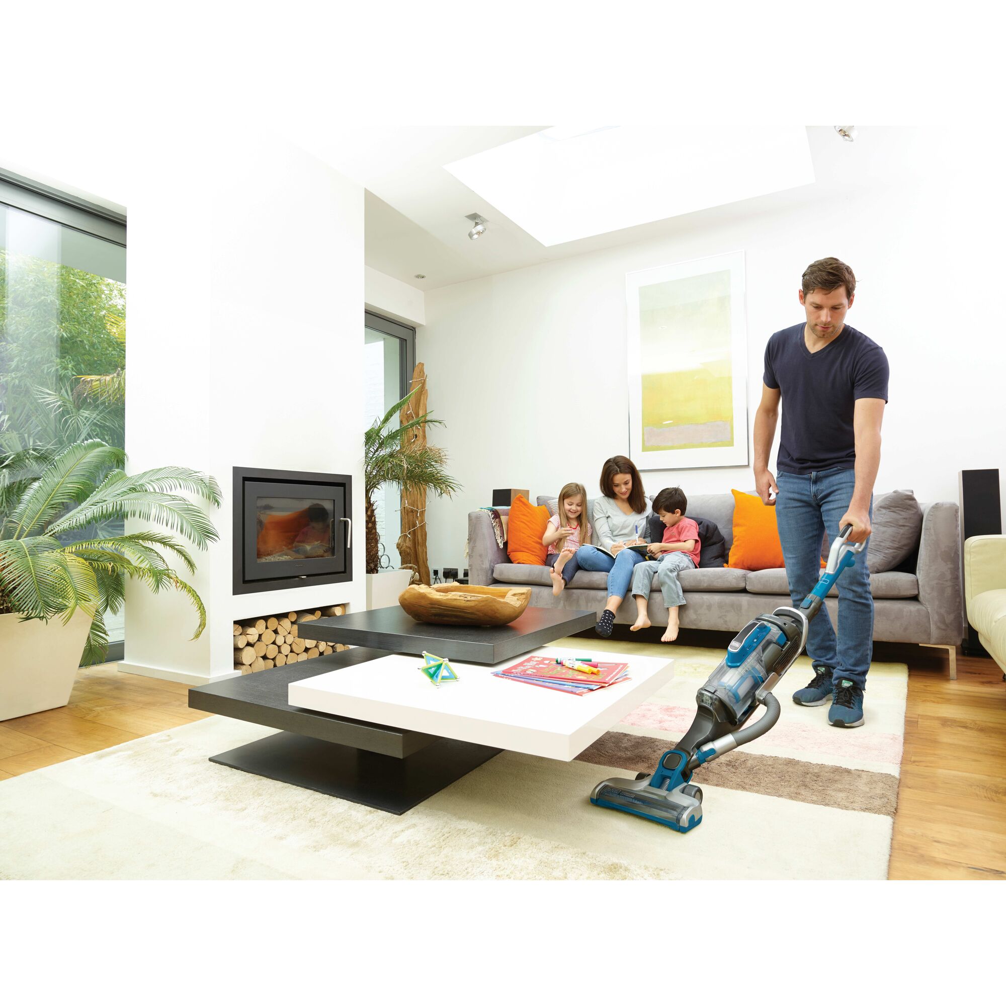 power series pro cordless 2 in 1 vacuum being used by a person in a living room.