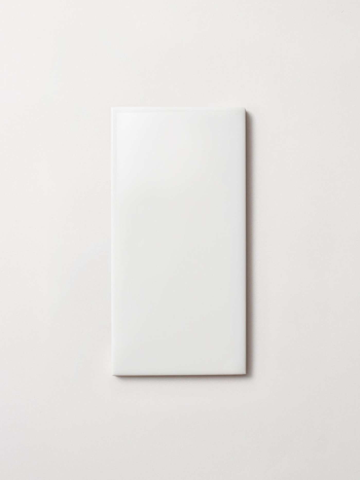 a white rectangle tile on a white surface.