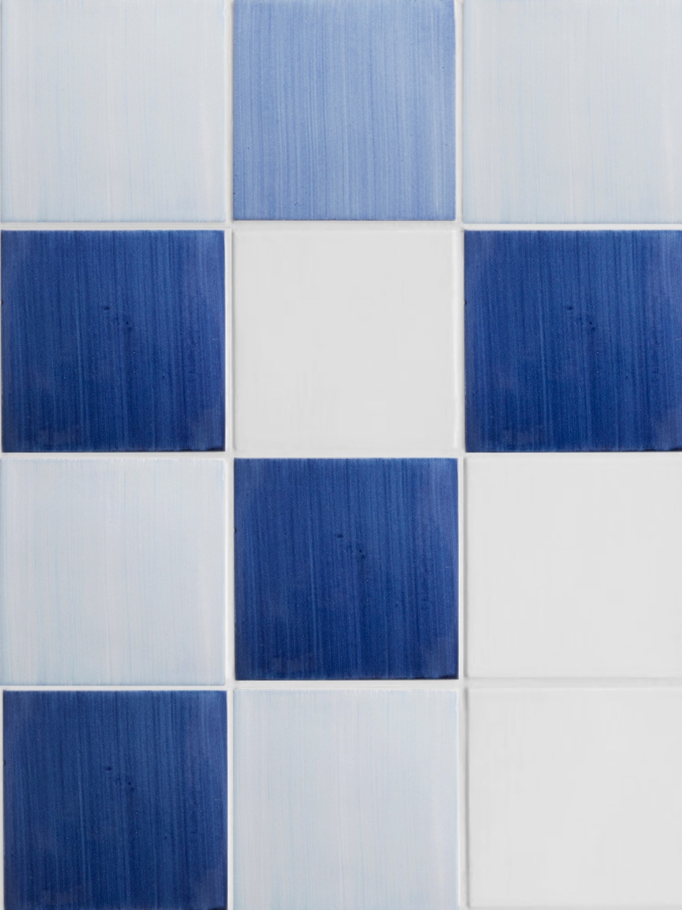 a blue and white tile with squares on it.