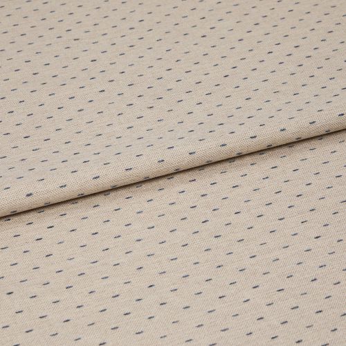 Beige woven fabric with regular small navy dash dots, folded once across center, lying flat on a neutral surface; close-up, even studio lighting highlighting its textured weave.