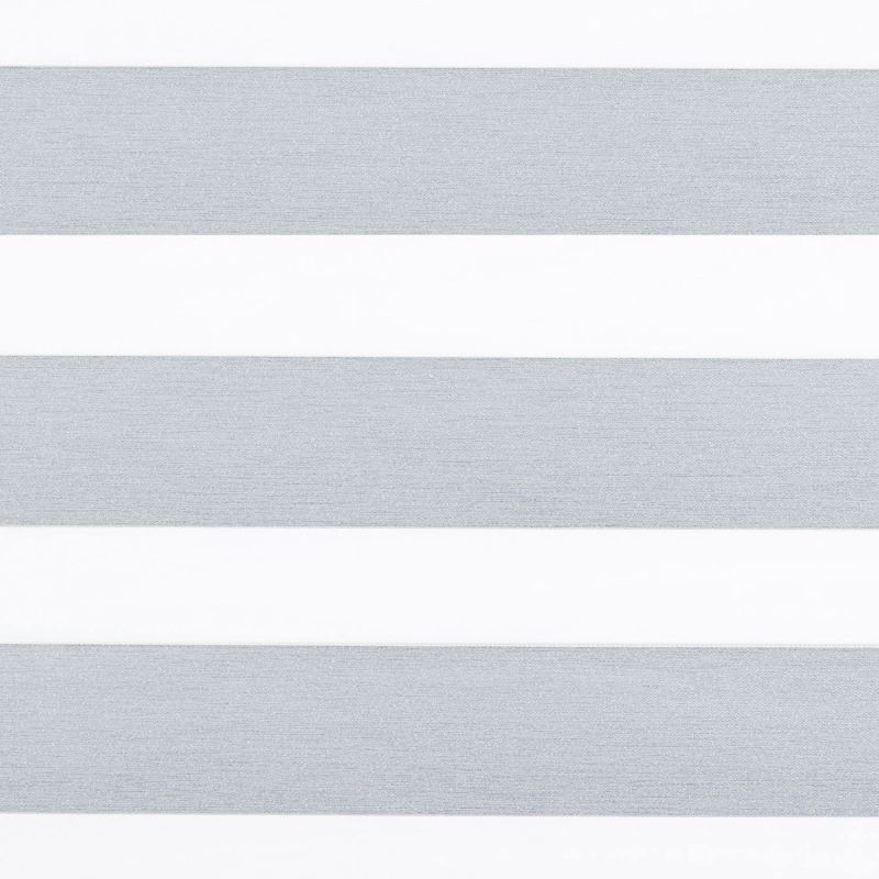 Horizontal dual-layer (zebra) roller blind covering a window, showing alternating textured gray opaque and white sheer bands that filter light; close-up view with neutral interior lighting.