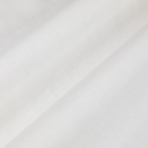 White fabric with a diagonal fold forming a soft shadowed ridge; light subtly diffused across its smooth woven texture in a bright, minimal interior.