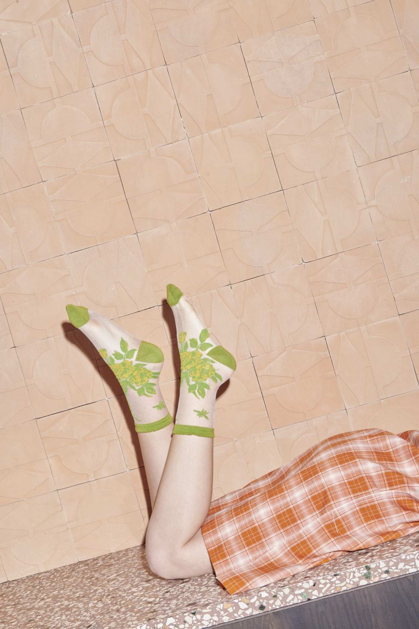 a woman laying on a tiled floor.