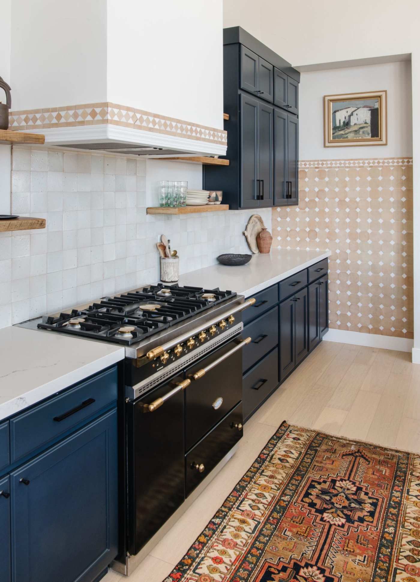 a kitchen with a stove and a rug.