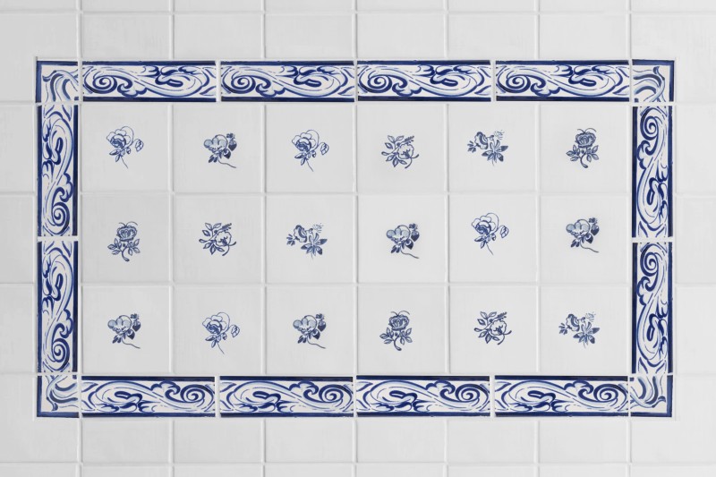 blue and white hand painted tiles with floral patterns.