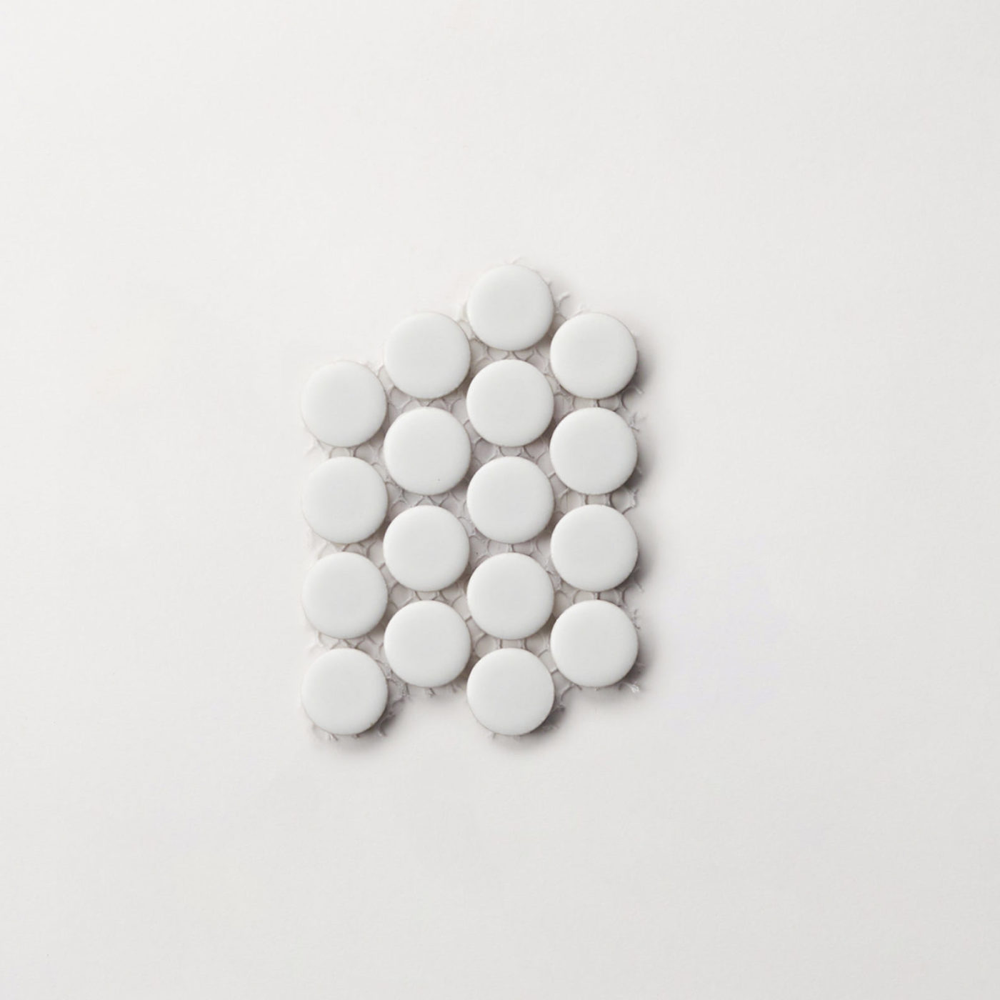 a group of white circles on a white surface.