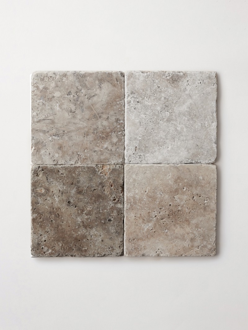 a set of four square tiles on a white surface.