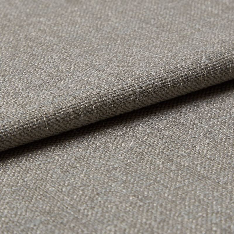Beige woven fabric folded over itself, showing a tight basket-weave texture; lying flat in soft, neutral lighting, close-up view emphasizing threads and subtle sheen.