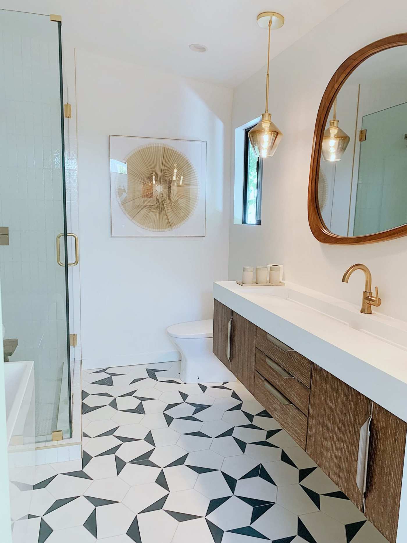 a bathroom with a black and white tile floor.